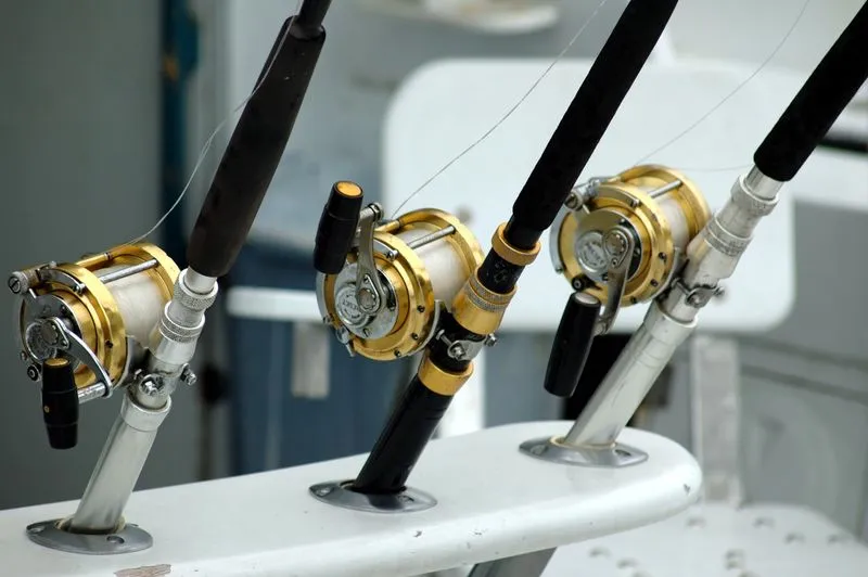 Three spinning reels spooled with braid, monofilament, and fluorocarbon side by side